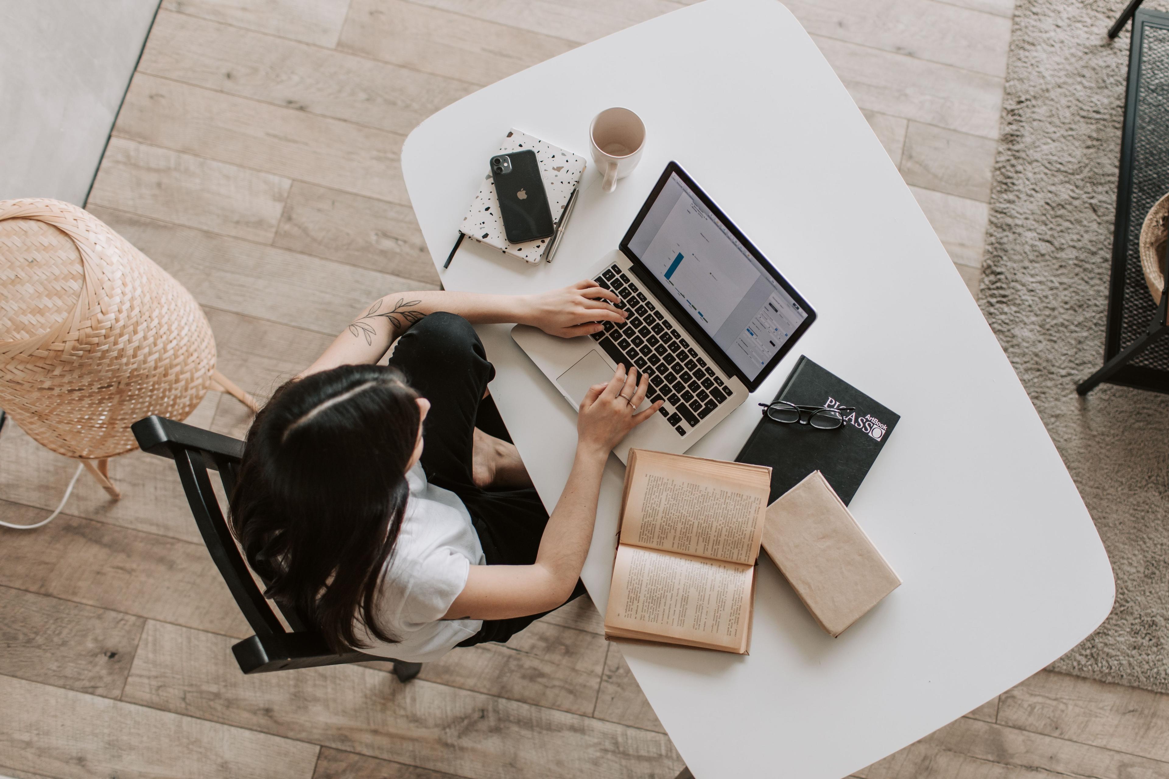 Employee working at a permanently set up home office workstation – telework Employee working at a permanently set up home office workstation – telework
